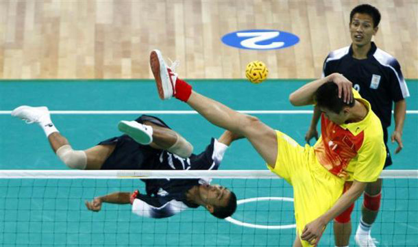 A member of the China team tries to block an overhead kick by a member of the India team during their men's team sepak takraw match at the 16th Asian Games in Guangzhou, Guangdong province. (REUTERS)