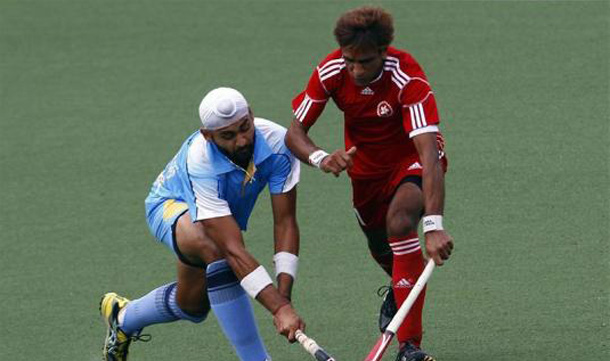 India's Singh Sandeep (L) challenges Hong Kong's Ali Asghar during their preliminary field hockey game at the 16th Asian Games in Guangzhou, Guangdong province. (REUTERS)