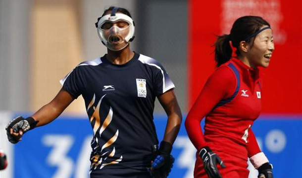India's Saba Anjum (L) reacts after missing a goal shot next to Japan's Ai Murakami during their preliminary women's field hockey game at the 16th Asian Games in Guangzhou, Guangdong province. (REUTERS)
