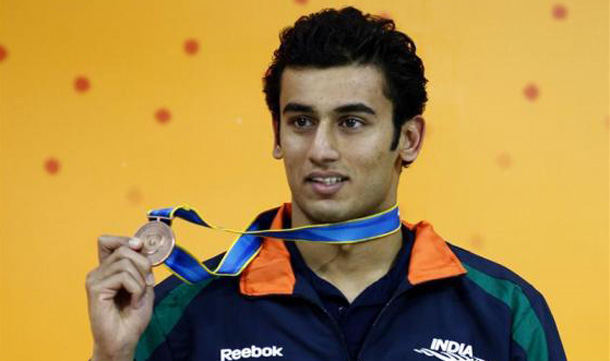 Virdhawal Vkram Khade of India holds his bronze medal during the medal ceremony for the men's 50m butterfly swimming event at the 16th Asian Games in Guangzhou, Guangdong province. (REUTERS)