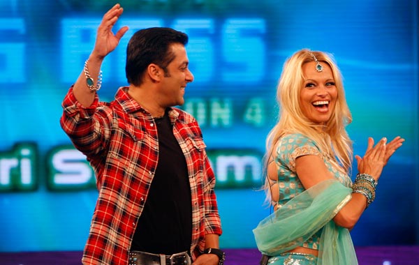 Former "Baywatch" star Pamela Anderson, right, dances with Bollywood actor Salman Khan on the sets of the Indian reality television show "Big Boss" in Mumbai, India. (AP