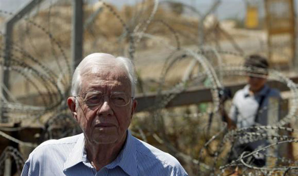 Former President Jimmy Carter stands in front of the controversial Israeli barrier during a visit to the West Bank village of Bilin near Ramallah. (REUTERS)