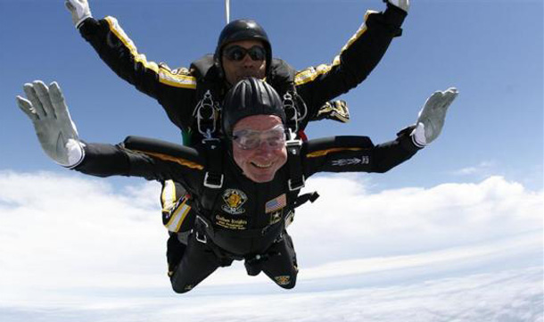 Former President George H.W. Bush (bottom) celebrates his 85th birthday by jumping with the Army's Golden Knight parachute team in Kennebunkport. (REUTERS)