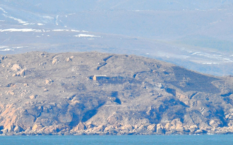 A file picture taken on January 28, 2010 shows a border area of North Korea's west coast as seen from South Korea's Yeonpyeong Island in the disputed waters of the Yellow Sea.  Several North Korean artillery shells landed on a South Korean border island on November 23, 2010 damaging homes and causing injuries,  YTN television reported.  (AFP)