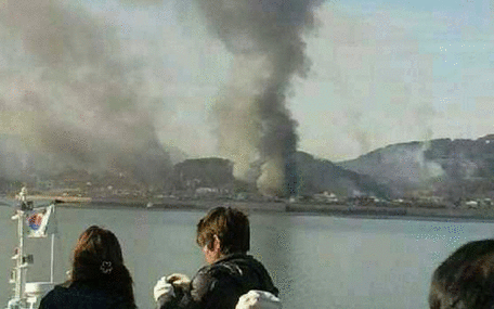 Smoke rises from South Korean Yeonpyeong Island after being hit by dozens of artillery shells fired by North Korea November 23, 2010. Several South Korean civilians and soldiers were wounded and many others were being evacuated to bunkers on Tuesday, a Seoul television reported. The island is located near the western maritime border between the two Koreas, 11 km (7 miles) from the North and about 115 km (71 miles) northwest of Seoul. (AGENCIES)