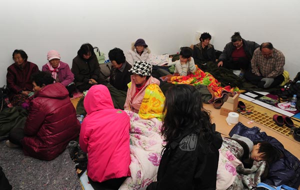 South Korean residents rest as they take shelter from North Korea's attack on Yeonpyeong island, South Korea. (AP)
