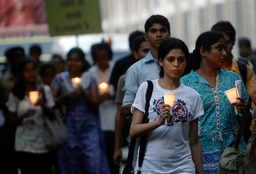 People hold candles and pay tribute to victims of the Mumbai terror attacks, in Mumbai, India, Thursday. (AP)