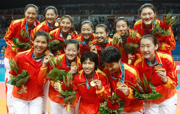 China's players celebrate with their gold medals during the victory ceremony for the women's volleyball at the 16th Asian Games in Guangzhou, China. (AP)
