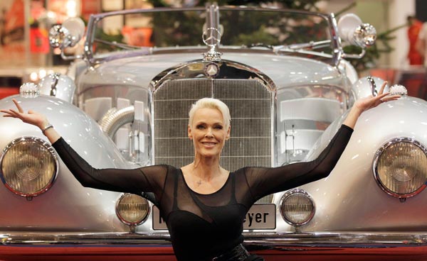 Danish actress Brigitte Nielsen poses in front of a 500 Mercedes Benz car, which was built in 1935, in Essen, Germany, Friday Nov. 26, 2010. The 500 Mercedes with an 8 cylinder OHV inline engine and a switchable Roots compressor was custom made for the former king of Iraq and is on display at the International Essen Motorshow Fair. (AP)