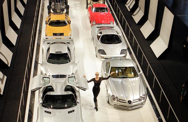 Danish actress Brigitte Nielsen poses amongst Mercedes Benz cars lined up in the history they were built, at the International Essen Motorshow Fair, in Essen. (AP)