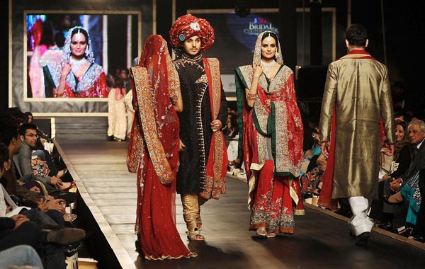 Models display creations by Pakistani designer Amna Ajmal during the Bridal Couture Week 2010 in Lahore. (AFP)