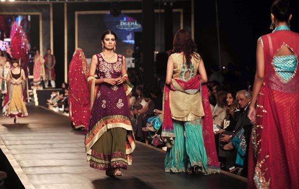 Models display creations by Pakistani designer Amna Ajmal during the Bridal Couture Week 2010 in Lahore. (AFP)
