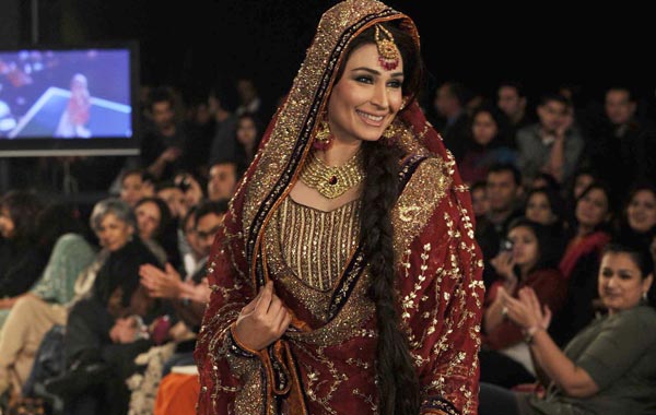 Pakistani film actress Reema walks wearing a bridal dress on the last day of Bridal Couture Week 2010 in Lahore. (AFP)
