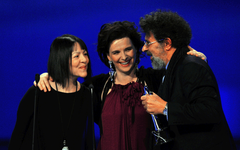 Lebanese composer Gabriel Yared (right) celebrates after receiving the European Film Academy European achievement in world cinema award at the 23rd European Film Awards, presented by French actress Juliette Binoche (right), the continent's version of the Oscars, in Tallinn. (AFP)