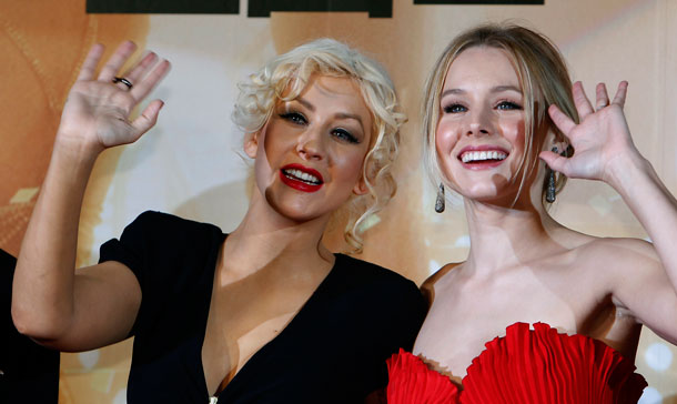 Singer and actress Christina Aguilera, left, and actress Kristen Bell wave during the Japan premiere of their film "Burlesque" in Tokyo, Japan. (AP)