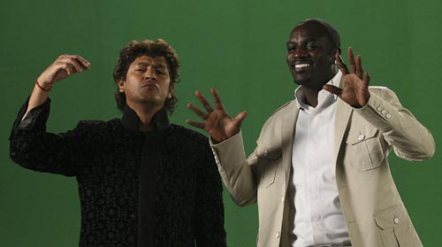 US singer Akon (R) performs with Indian music director Aadesh Shrivastava during a music video filming for the English-Hindi album 'One for the World' in Mumbai on December 8. The album is an attempt to create harmony and peace in the world as told by Akon and is a call for international brotherhood. (AFP)