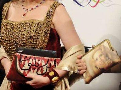 The handbag of Egyptian television presenter Hala Serhan is seen beside actress Poussy Shalabi's purse with a picture of Lebanese singer and actress Sabah, a Lifetime Achievement award honoree alongwith Souleyman Cisse and Sean Penn this year, on the red carpet for the opening ceremony of the 7th edition of the Dubai International Film Festival (REUTERS)