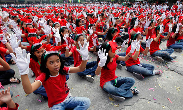Students perform the Christmas song "Rudolph The Red Nosed Reindeer" during a school event in Manila. (REUTERS)
