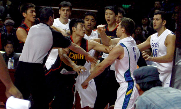 Chinese (black and red) and Brazilian (white and blue) basketball players brawl during a friendly match between the two teams in Xuchang, in central China's Henan province.  Basketball's world governing body FIBA has fined and suspended China's national team coach along with three players after a bench-clearing brawl put an end to a friendly match with Brazil in October. Team China's coach Bob Donewald was suspended for three games and fined 40,000 Swiss francs (40,900 USD), FIBA said in a statement on its website. (AFP)