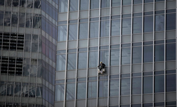 Worker cleans windows of a high-rise building in Shanghai, China. The prolonged weakness in the US and Europe may be the least of Asia's troubles in 2011, economists say, as the region fights potentially destabilizing inflationary pressures. (AP)