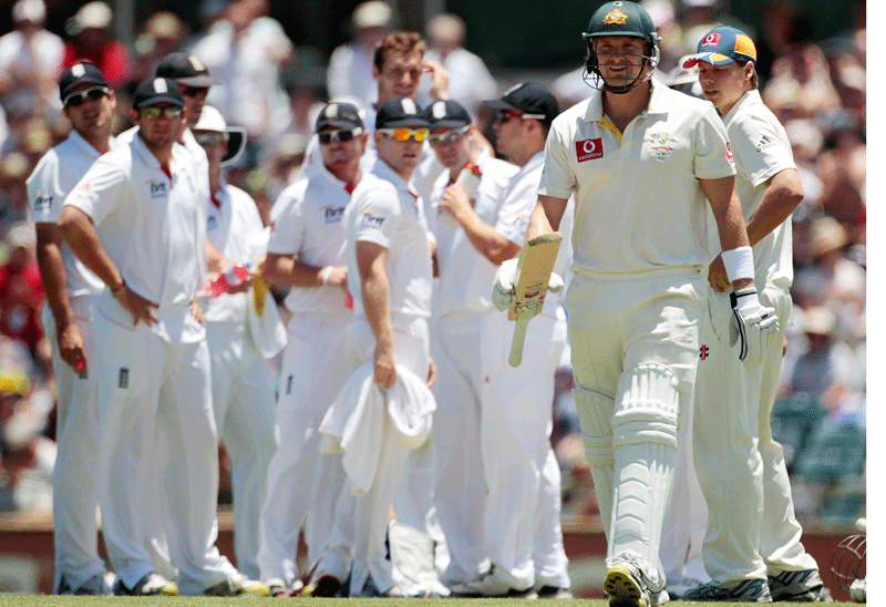 England's players watch Australia's Shane Watson walk from the field after being dismissed by Chris Tremlett during the third Ashes Test at the Waca ground in Perth on Saturday. (REUTERS)