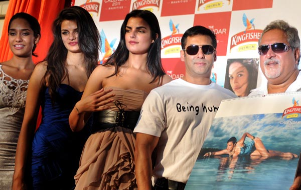 Indian Bollywood actor Salman Khan (2R) and United Breweries group chairman Vijay Mallya (R) pose with the calendar models during the launch of the 'Kingfisher Swimsuit Special Calendar 2011' in Mumbai. (AFP)