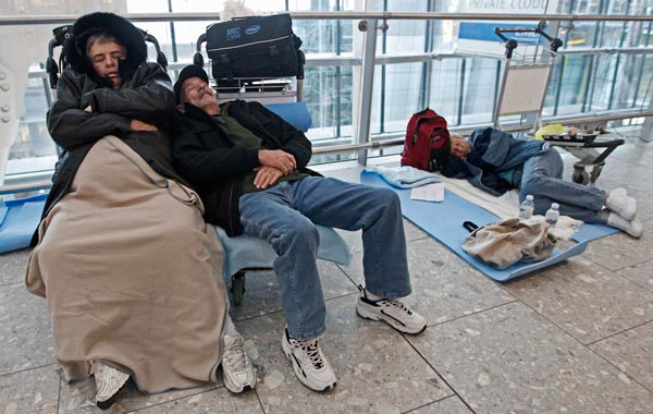 Airline passengers sleep in Terminal 5 at Heathrow Airport, in west London. (REUTERS)