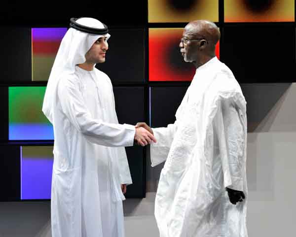 His Highness Sheikh Saeed Bin Mohammed Bin Rashid Al Maktoum shakes hands with Lifetime Achievement honouree director Souleymane Cisse on stage during the Closing Night Muhr Awards Ceremony of the Dubai International Film Festival (GETTY IMAGES)