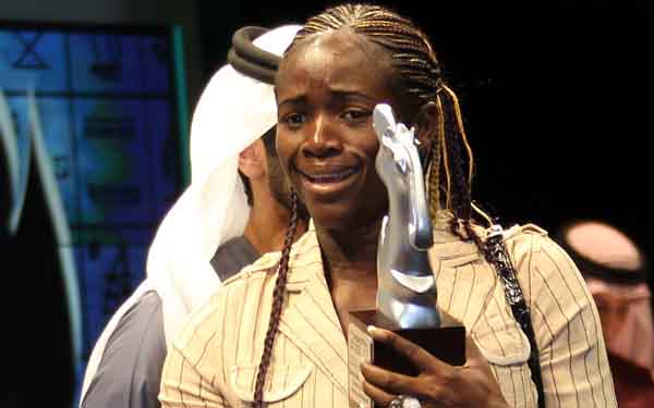 Cameroonian director Ariane Astrid Atodji (R) receives the special jury price for her documentary film 'Koundi and the National Thursday' during the closing ceremony of the Seventh Dubai International Film Festival (AFP)