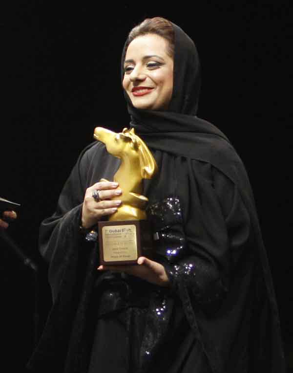 Emirati filmmaker Nayla Al Khaja accepts the first prize for 'Malal' (Bored) in the Muhr Emirati category during the closing night and awards ceremony of the 7th Dubai International Film Festival on Sunday (REUTERS)