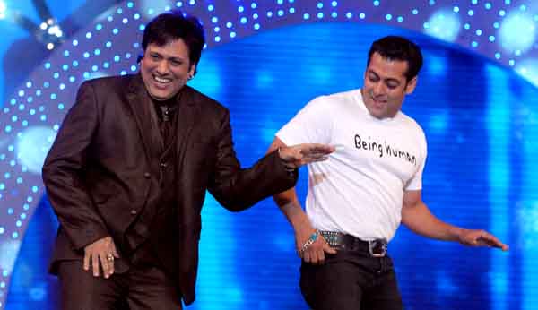 Dancing for the cops: Govinda and Salman Khan perform on stage at 'Mumbai Police Umang 2011' (AFP)