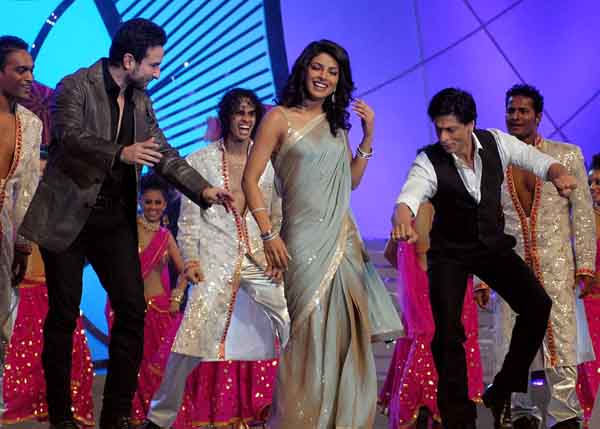 Bollywood song and dance: Saif Ali Khan, Priyanka Chopra and Shah Rukh Khan dance on the stage of 'Mumbai Police Umang 2011' on December 19 (AFP)