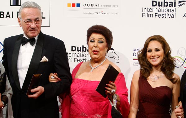 Egyptian actors Ezzat Abu-Ouf (L), Ragaa El-Gedawy (C) and Sherine Adel arrive for the red carpet closing night and awards ceremony of the 7th Dubai International Film Festival. (REUTERS)
