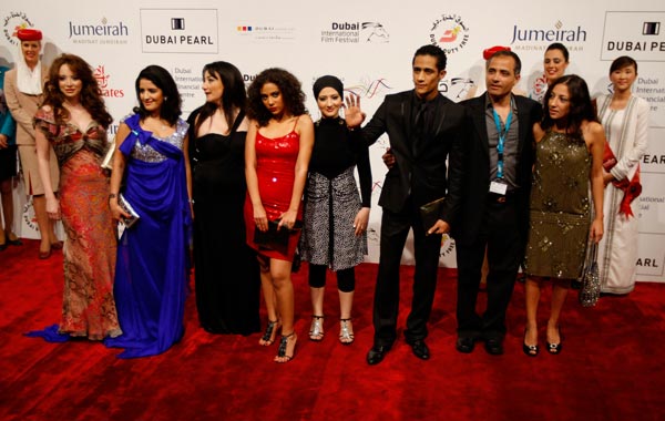 Egyptian director of "Cairo Exit" Hesham Issawi (2nd R) poses with cast members on the red carpet during the closing ceremony of the 7th Dubai International Film Festival. (REUTERS)