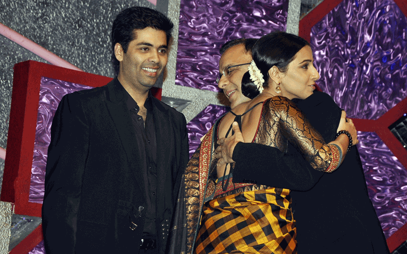 Indian Bollywood film director Karan Johar looks as actress Vidya Balan greets director Vidu Vinod Chopra during the "Big Star Entertainment Awards" ceremony in Mumbai. (AFP)