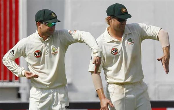Australia's Michael Clarke (L) and Shane Watson gesture during the third day of their second test cricket match against India in Bangalore. (REUTERS)