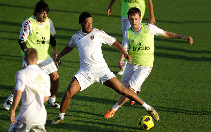 AC Milan's Brazilian forward Ronaldinho, center and Antonio Cassano, right, fight for the ball during a training session at the Al Ahli club in Dubai, United Arab Emirates. AC Milan will play against Al Ahli club in Dubai on Jan. 2, 2011. (AP)