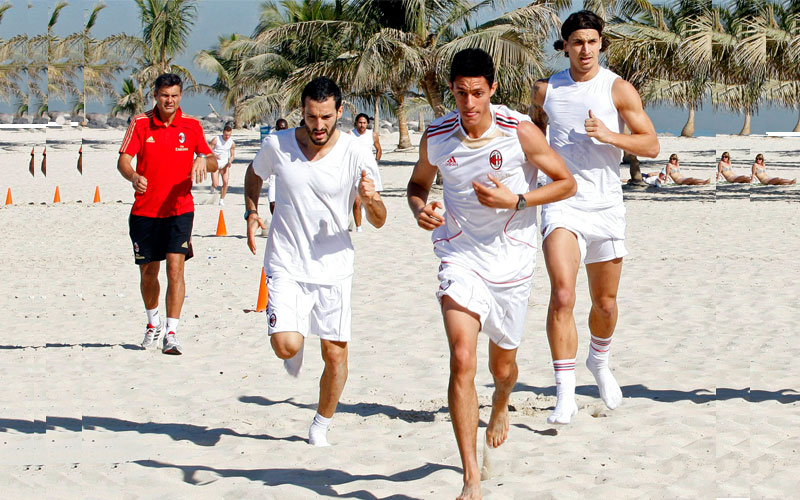 AC Milan's Gianluca Zambrotta (2nd L), Bruno Montelongo (2nd R) and Zlatan Ibrahimovic (R) run during a training session at Al Mamzar Beach Park in Dubai. (REUTERS)