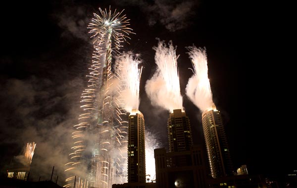 The Dubai Burj Khalifa lights up at midnight during a fireworks display to celebrate the New Year in Dubai, United Arab Emirates. (AP)