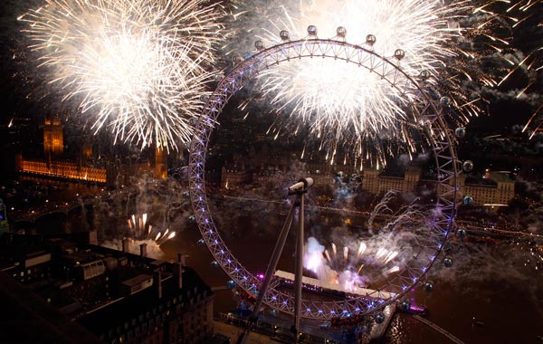 Fireworks explode beside the London Eye and The Houses of Parliament on the River Thames during New Year celebrations in London. (REUTERS)