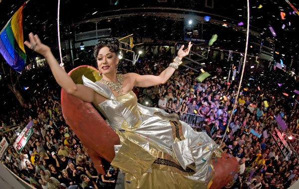 "Sushi," portrayed by female impersonator Gary Marion, dangles high above New Year's Eve revelers in a giant reproduction of a woman's high heel at the Bourbon Street Pub. (AFP)