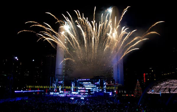 Fireworks erupt before the Toronto City Hall to mark the New Year's celebrations in downtown Toronto at midnight. (AP)