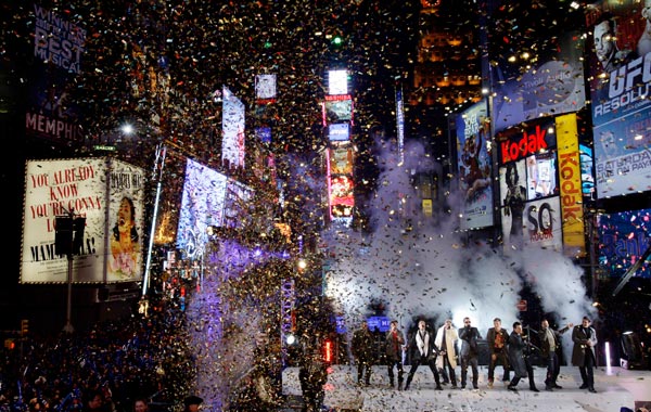 While confetti falls, the New Kids on the Block and the Backstreet Boys perform for the crowds awaiting the new year in Times Square in New York. (AP)