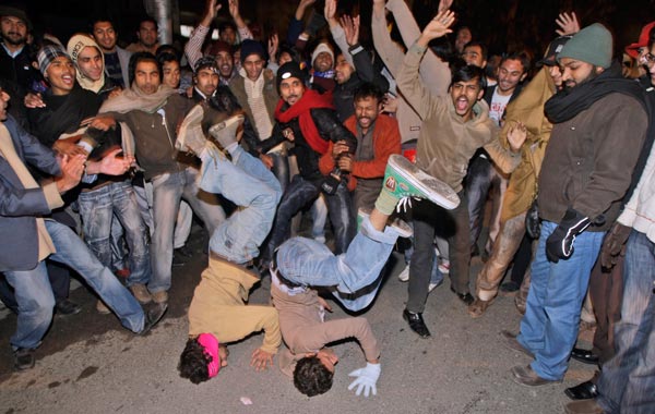Pakistanis dance in a street celebrating the New Year in Lahore, Pakistan. (AP)