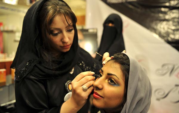 A Saudi woman applies makeup on a woman on the sidelines of a beauty and style competition during the 2010 Cosmetic Expo, a four-day exhibition held for the first time in Saudi Arabia, at a hotel in the coastal city of Jedda. (AFP)