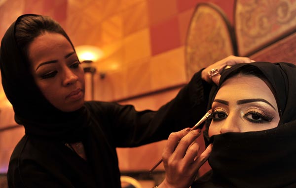 A Saudi woman applies makeup on a model during a beauty and style competition on the sidelines of the 2010 Cosmetic Expo, a four-day exhibition held for the first time in Saudi Arabia, at a hotel in the coastal city of Jeddah. (AFP)