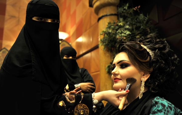 A Saudi woman applies makeup on a model during a beauty and style competition on the sidelines of the 2010 Cosmetic Expo, a four-day exhibition held for the first time in Saudi Arabia, at a hotel in the coastal city of Jeddah. (AFP)