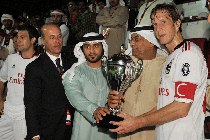 AC Milan captain Massimo Ambrosini (right) receiving the Emirates Challenge Cup after defeating Al Ahli 2-1 on Sunday. (SUPPLIED)