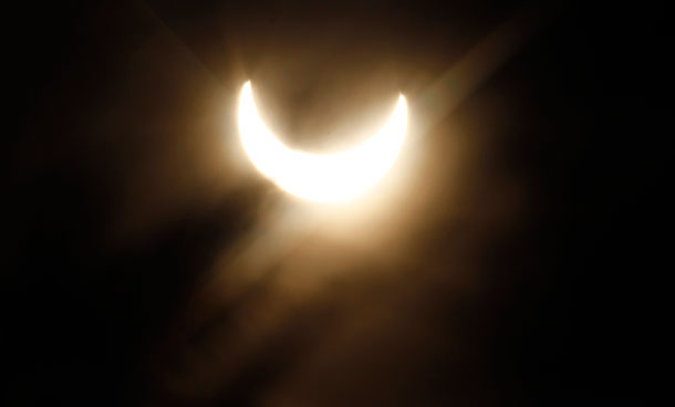 A partial solar eclipse is pictured in the fog over the roofs in Vienna, Austria, on Tuesday, Jan. 4, 2011. (AP)