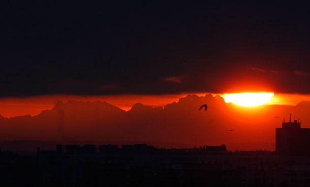 A general view shows the Bavarian Alps during sunrise shortly after the start of a partial solar eclipse in Munich January 4, 2011. (REUTERS)